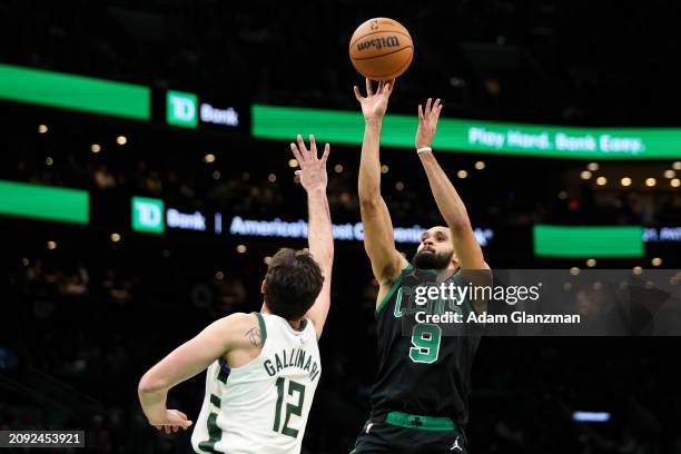 Derrick White of the Boston Celtics shoots against Danilo Gallinari of the Milwaukee Bucks in the third quarter at TD Garden on March 20, 2024 in...