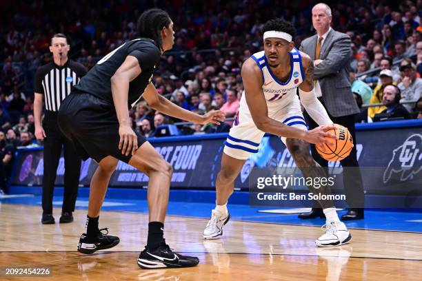 Chibuzo Agbo of the Boise State Broncos looks to pass against Cody Williams of the Colorado Buffaloes during the First Four round of the 2024 NCAA...