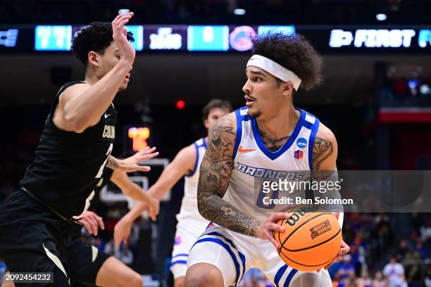 Roddie Anderson of the Boise State Broncos looks to pass against KJ Simpson of the Colorado Buffaloes during the First Four round of the 2024 NCAA...