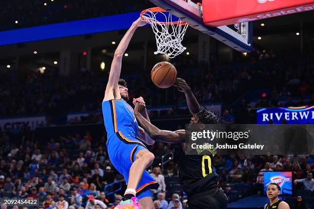 Chet Holmgren of the Oklahoma City Thunder dunks the ball over Taylor Hendricks of the Utah Jazz during the second half at Paycom Center on March 20,...