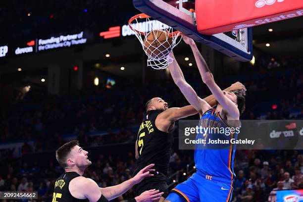 Chet Holmgren of the Oklahoma City Thunder finishes a dunk against Talen Horton-Tucker of the Utah Jazz during the second half at Paycom Center on...