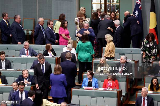 Former Labor Party minister Joel Fitzgibbon is embraced by members of the parliament after condolence speeches for the death of his son Jack...