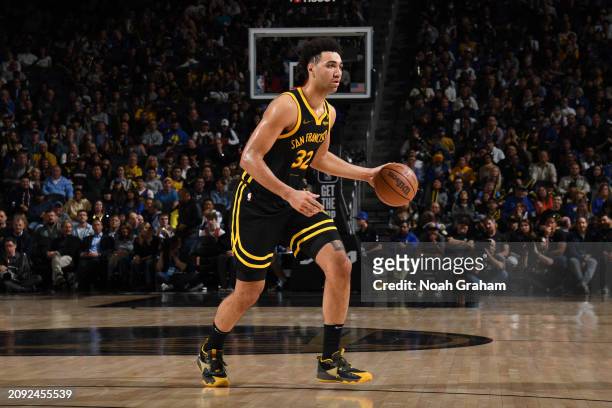Trayce Jackson-Davis of the Golden State Warriors dribbles the ball during the game against the Memphis Grizzlies on March 20, 2024 at Chase Center...