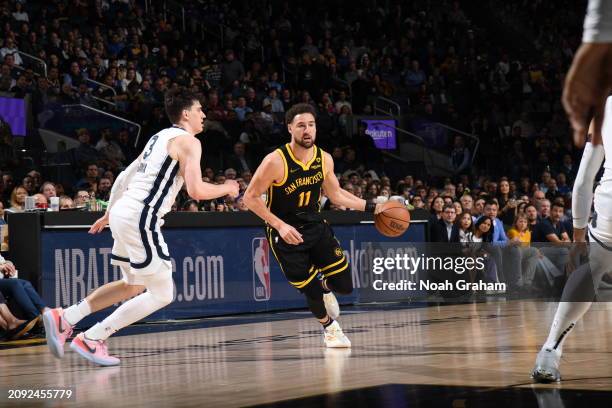 Klay Thompson of the Golden State Warriors dribbles the ball during the game against the Memphis Grizzlies on March 20, 2024 at Chase Center in San...