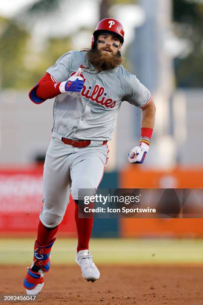 Philadelphia Phillies left fielder Brandon Marsh runs the bases after an RBI triple in the third inning of an MLB spring training game against the...