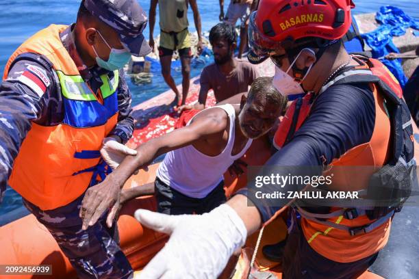 Rohingya refugee is rescued from their capsized boat by National Search and Rescue Agency personnel in waters some 16 nautical miles off west Aceh on...