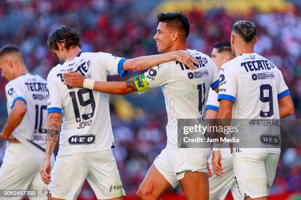 Maximiliano Meza of Monterrey celebrates with teammates after scoring the team's first goal during the 12th round match between Atlas and Monterrey...