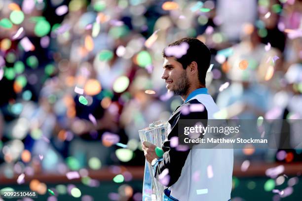 Carlos Alcaraz of Spain poses with the trophy after defeating Daniil Medvedev of Russia during the Men's Final of the BNP Paribas Open at Indian...