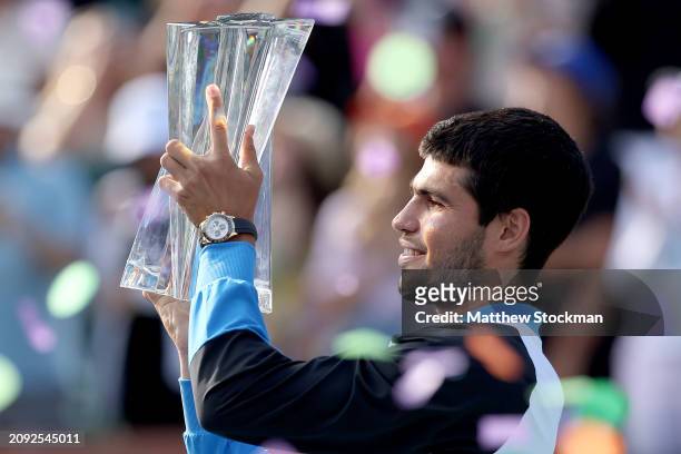 Carlos Alcaraz of Spain poses with the trophy after defeating Daniil Medvedev of Russia during the Men's Final of the BNP Paribas Open at Indian...