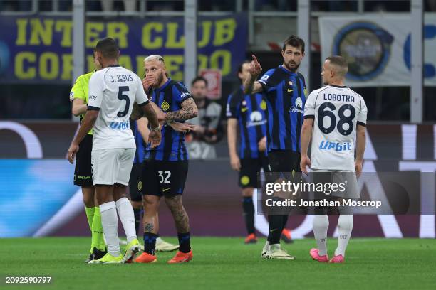 Stanislav Lobotka of SSC Napoli and Nicolo Barella and Francesco Acerbi of FC Internazionale look on as the Referee e Federico La Penna intervenes as...