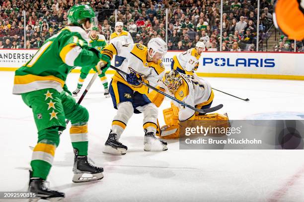 Gustav Nyquist and Juuse Saros of the Nashville Predators defend against Adam Beckman of the Minnesota Wild during the game at the Xcel Energy Center...