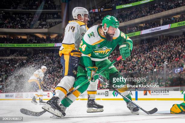 Zach Bogosian of the Minnesota Wild defends Gustav Nyquist of the Nashville Predators during the game at the Xcel Energy Center on March 10, 2024 in...