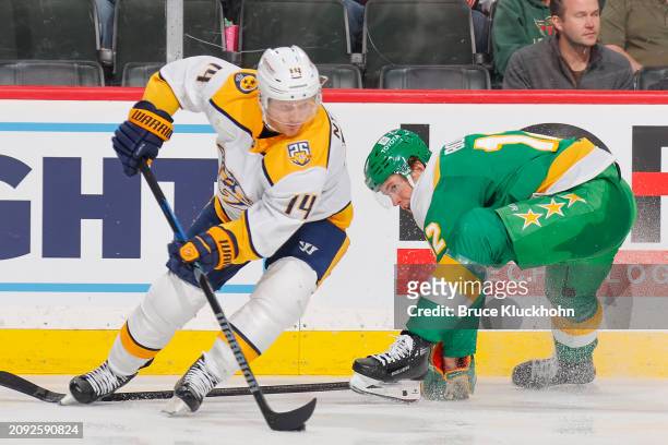 Gustav Nyquist of the Nashville Predators handles the puck with Matt Boldy of the Minnesota Wild defending during the game at the Xcel Energy Center...