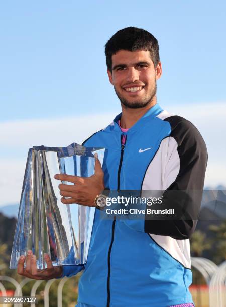 Carlos Alcaraz of Spain holds his winners trophy at the media photocall after his straight sets victory against Daniil Medvedev in the Men's Final...