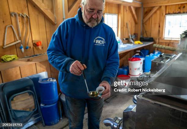 Pat LeClaire pours fresh maple syrup into a cup in the building where he boils sap collected from nearby maple trees March 8, 2024 in Charlotte,...