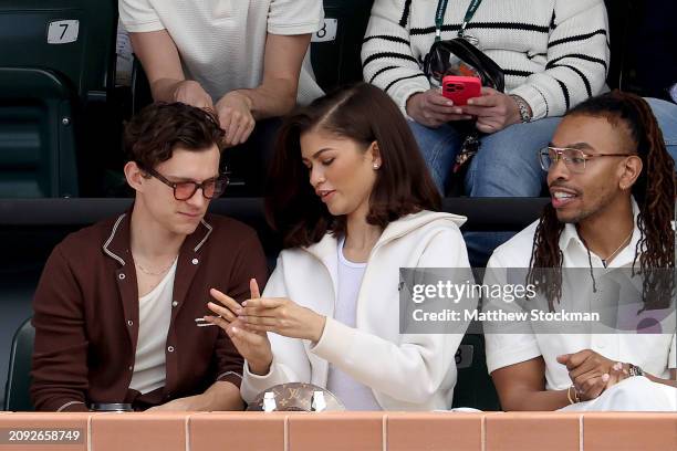 Tom Holland and Zendaya watch Carlos Alcaraz of Spain play Daniil Medvedev of Russia during the Men's Final of the BNP Paribas Open at Indian Wells...