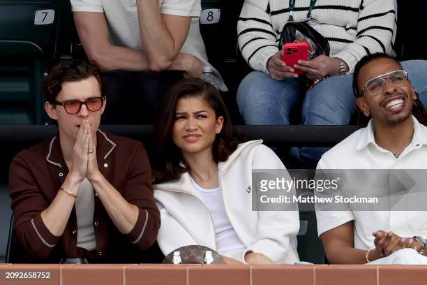 Tom Holland and Zendaya watch Carlos Alcaraz of Spain play Daniil Medvedev of Russia during the Men's Final of the BNP Paribas Open at Indian Wells...
