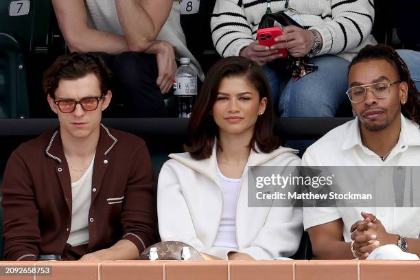 Tom Holland and Zendaya watch Carlos Alcaraz of Spain play Daniil Medvedev of Russia during the Men's Final of the BNP Paribas Open at Indian Wells...