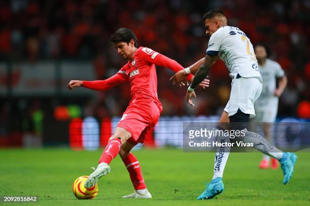 Carlos Orrantia of Toluca battles for possession with Robert Ergas of Pumas UNAM during the 12th round match between Toluca and Pumas UNAM as part of...