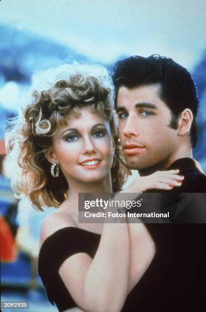 Actors John Travolta and Olivia Newton-John embrace in a promotional still for the film, 'Grease,' directed by Randal Kleiser, 1978.