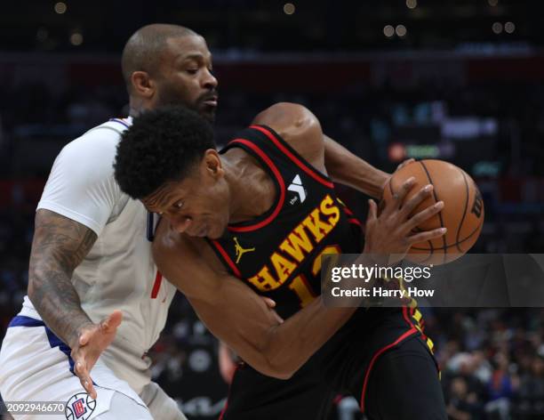 De'Andre Hunter of the Atlanta Hawks posts up P.J. Tucker of the LA Clippers during a 110-93 Hawks win at Crypto.com Arena on March 17, 2024 in Los...