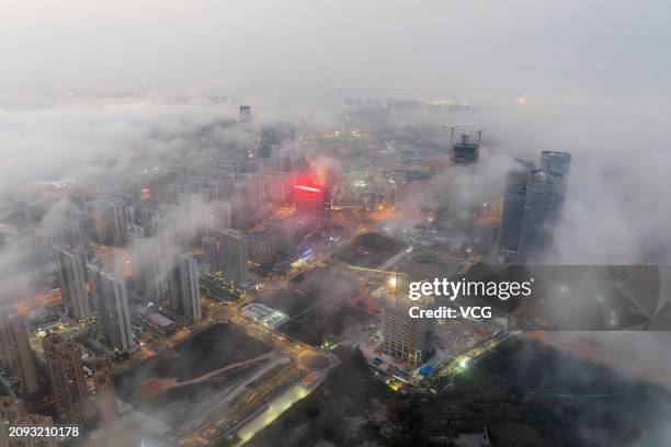 Buildings are seen amid advection fog on March 17, 2024 in Xiamen, Fujian Province of China.