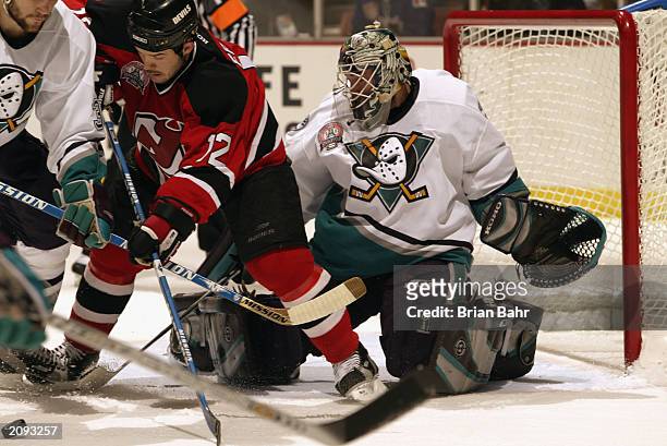 Jeff Friesen of the New Jersey Devils scrambles for the puck against Keith Carney of the Anaheim Mighty Ducks during Game Six of the 2003 Stanley Cup...