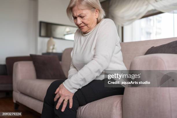 senior woman having knee pain - calcification stock pictures, royalty-free photos & images