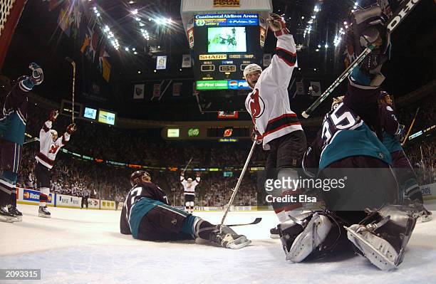 John Madden of the New Jersey Devils celebrates a goal against Jean-Sebastien Giguere of the Mighty Ducks of Anaheim in game five of the 2003 Stanley...