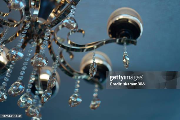 elegant opulence: luxury chandelier illuminating glamorous interiors - crystal chandelier stock pictures, royalty-free photos & images