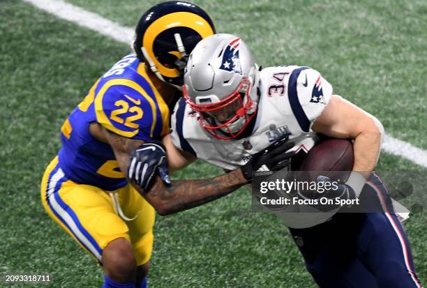 Rex Burkhead of the New England Patriots fights off the tackle of Marcus Peters of the Los Angeles Rams in the second half of Super Bowl LIII on...