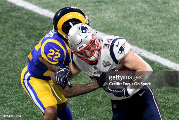 Rex Burkhead of the New England Patriots fights off the tackle of Marcus Peters of the Los Angeles Rams in the second half of Super Bowl LIII on...