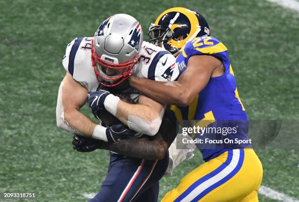 Rex Burkhead of the New England Patriots fights off the tackle of Marcus Peters of the Los Angeles Rams in the second half of Super Bowl LIII on...