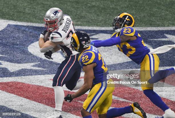 Rex Burkhead of the New England Patriots running with the ball pursued by Marcus Peters and Nickell Robey-Coleman of the Los Angeles Rams in the...