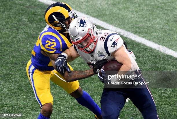 Rex Burkhead of the New England Patriots fights off the tackle of Marcus Peters of the Los Angeles Rams in the second half of Super Bowl LIII on...