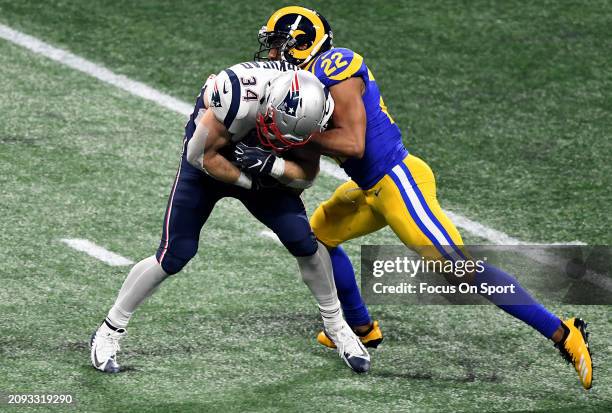 Rex Burkhead of the New England Patriots fights off the tackle of Marcus Peters of the Los Angeles Rams in the second half of Super Bowl LIII on...