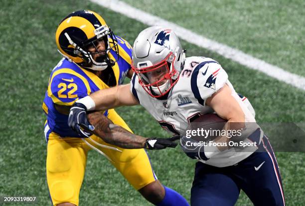 Rex Burkhead of the New England Patriots fights off the tackle of Marcus Peters of the Los Angeles Rams in the second half of Super Bowl LIII on...