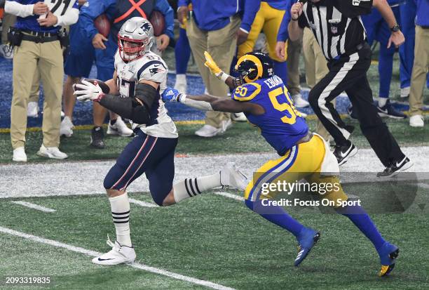 Rob Gronkowski of the New England Patriot runs with the ball pursued by Samson Ebukam of the Los Angeles Rams in the second half of Super Bowl LIII...