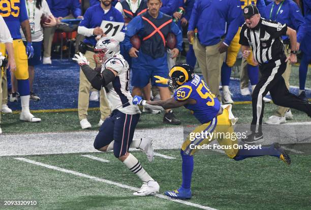 Rob Gronkowski of the New England Patriot runs with the ball pursued by Samson Ebukam of the Los Angeles Rams in the second half of Super Bowl LIII...