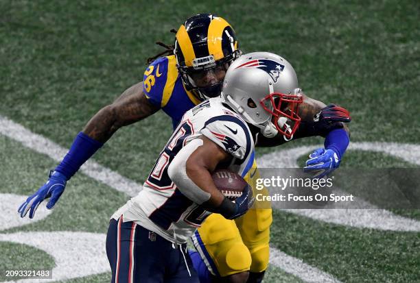 James White of the New England Patriots fights off the tackle of Mark Barron of the Los Angeles Rams in the second half of Super Bowl LIII on...