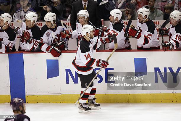 Brian Gionta of the New Jersey Devils is congratulated as he heads to the bench after scoring against the Mighty Ducks of Anaheim in game five of the...