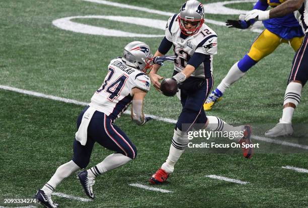 Tom Brady of the New England Patriots turns to handoff to running back Rex Burkhead against the Los Angeles Rams in the first half of Super Bowl LIII...