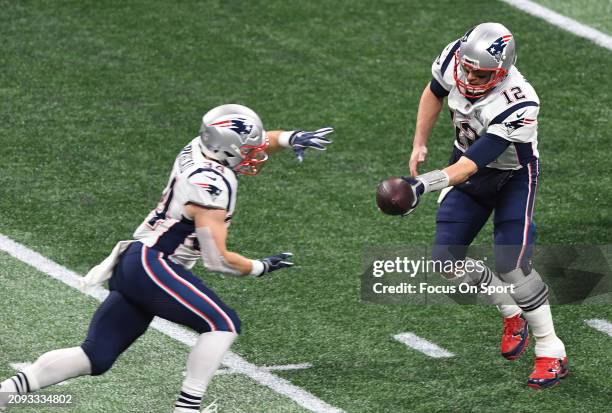 Tom Brady of the New England Patriots turns to handoff to running back Rex Burkhead against the Los Angeles Rams in the first half of Super Bowl LIII...