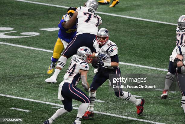 Tom Brady of the New England Patriots fakes a handoff to Rex Burkhead against the Los Angeles Rams in the second half of Super Bowl LIII on February...