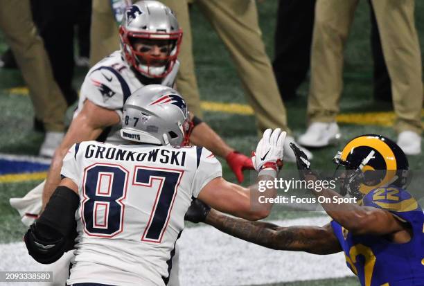 Rob Gronkowski to the New England Patriots running with the ball fights off the tackle of Marcus Peters of the Los Angeles Rams in the first half of...