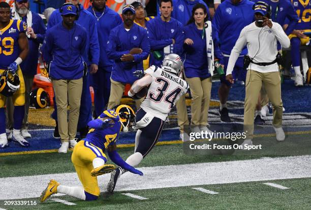 Rex Burkhead of the New England Patriots gets tackled out of bounds by John Johnson of the Los Angeles Rams in the first half of Super Bowl LIII on...