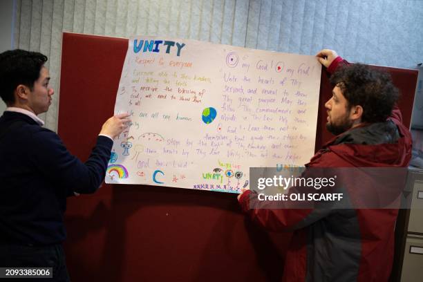 Members of the Baha'i faith put up a poster in the Ida Kinsey Centre to celebrate Nowruz , marking the spring equinox and beginning of the Baha'i New...