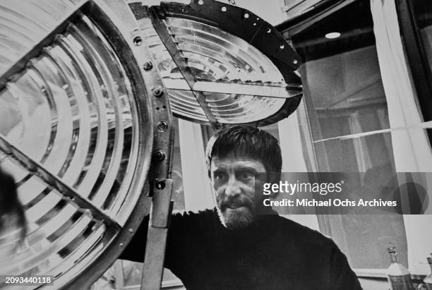 American actor and film director Kirk Douglas with the Fresnel lens of a lighthouse a scene from 'The Light at the Edge of the World', filmed in...