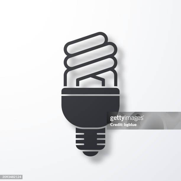 fluorescent light bulb. icon with shadow on white background - recycling electronics stock illustrations