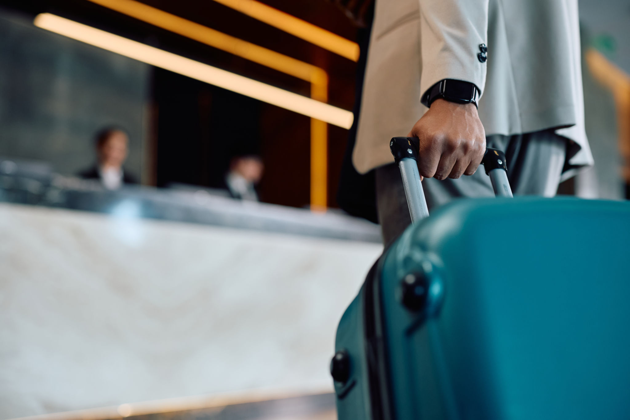 Close up of black man with suitcase arriving at the hotel. Close up of black man with suitcase arriving at the hotel.